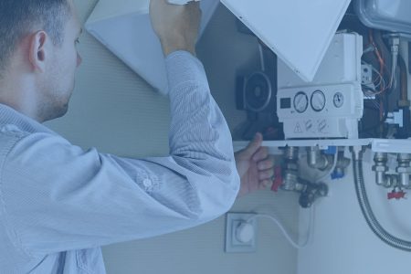 Plumber attaches Trying To Fix the Problem with the Residential Heating Equipment. Repair of a gas boiler